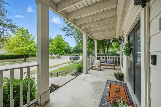 a view of a porch with chairs and backyard