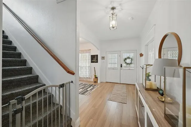 a view of a living room and entryway with wooden floor