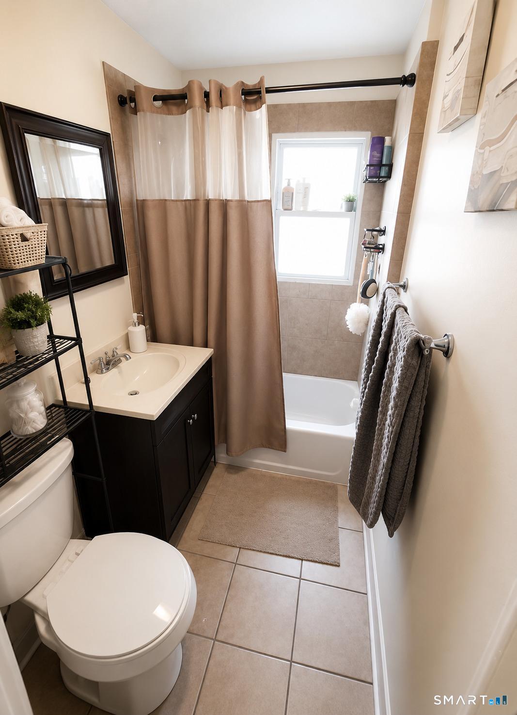 61 Bartlett Street Meriden, CT 06451 - Photo 20 of 30 a bathroom with a sink a toilet a mirror and shower