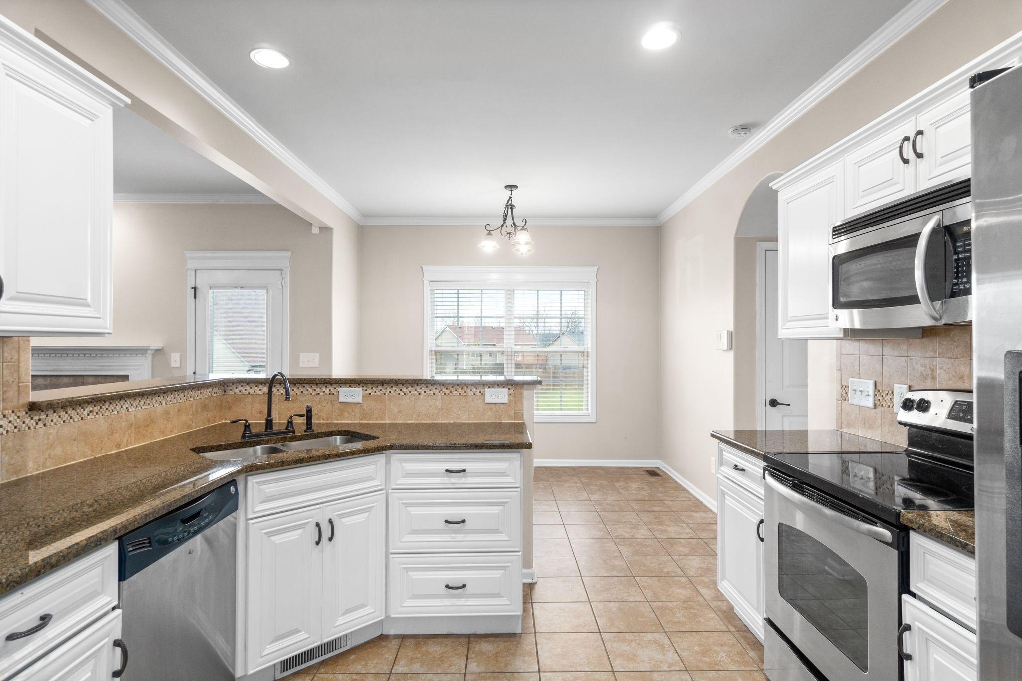 1431 Raven Road Clarksville, TN 37042 - Photo 12 of 32 a kitchen with granite countertop a sink stainless steel appliances and cabinets