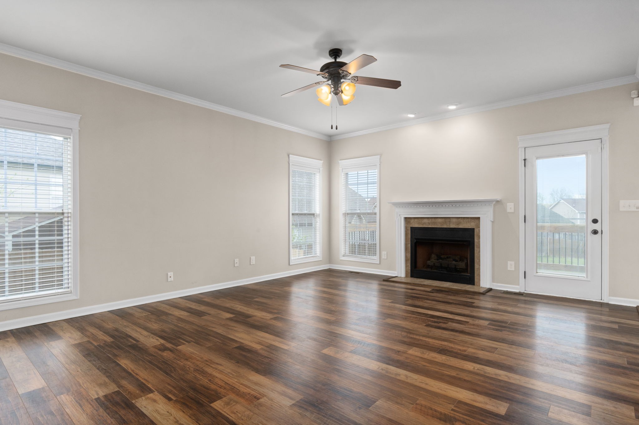 1431 Raven Road Clarksville, TN 37042 - Photo 6 of 32 an empty room with wooden floor fan and windows