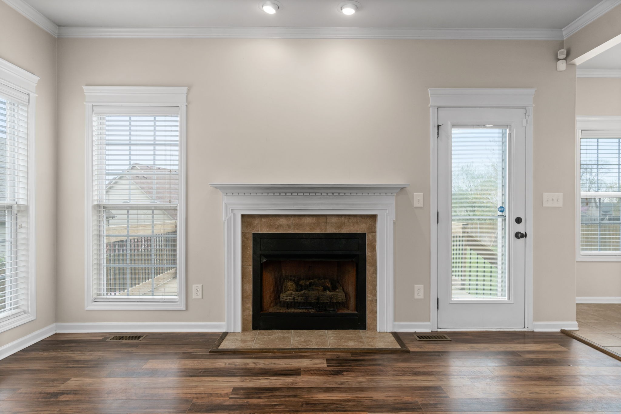 1431 Raven Road Clarksville, TN 37042 - Photo 7 of 32 a living room with a fireplace and wooden floor