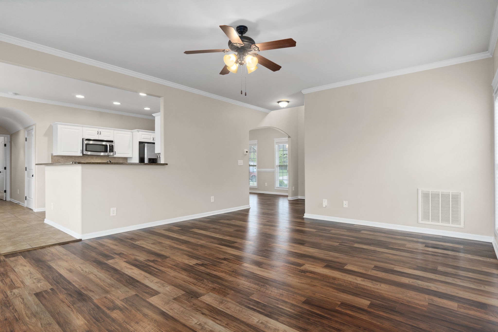 1431 Raven Road Clarksville, TN 37042 - Photo 9 of 32 a view of an empty room with wooden floor and a ceiling fan