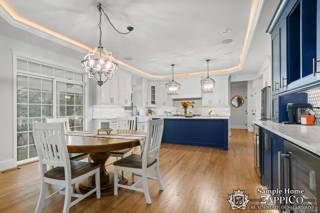 a kitchen with stainless steel appliances granite countertop wooden floors granite counter tops and a view of living room