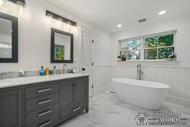 a white bath tub sitting next to a toilet