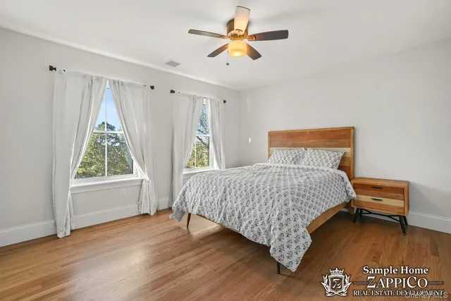 a spacious bathroom with a double vanity sink a mirror and a bathtub