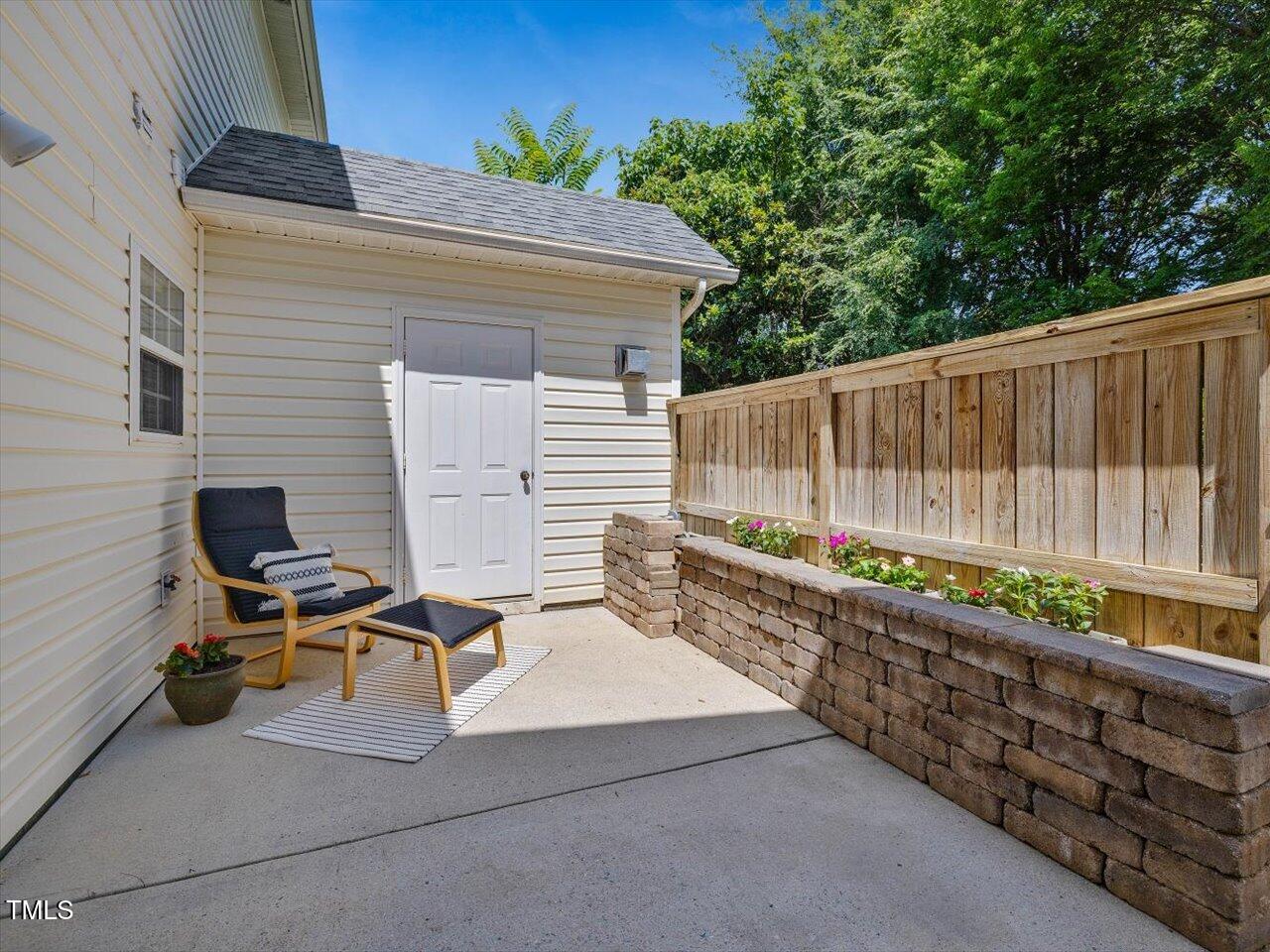 2021 Rivergate Road, Unit 102 Raleigh, NC 27614 - Photo 11 of 42 a view of a chairs and table in the back yard of the house