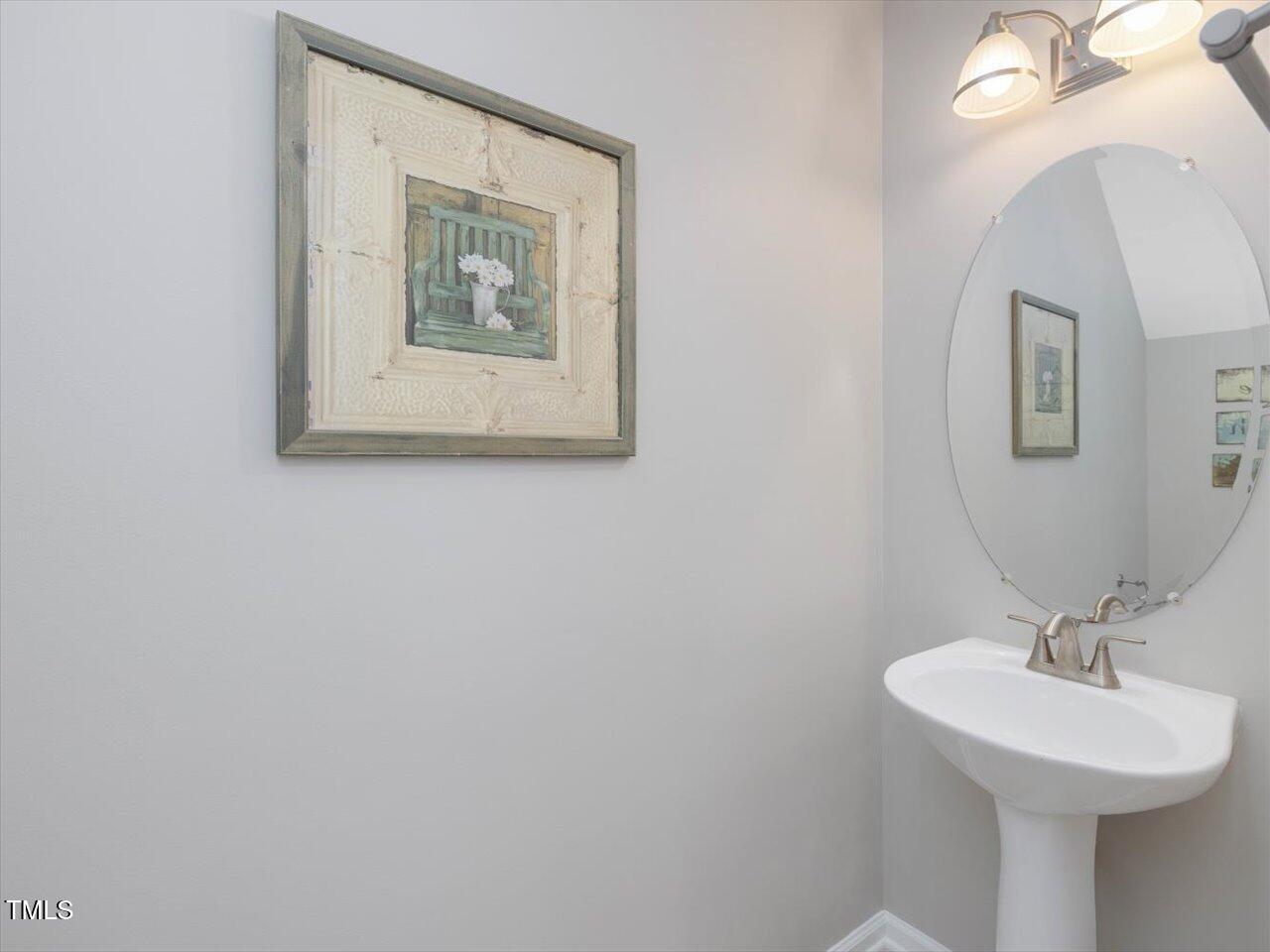2021 Rivergate Road, Unit 102 Raleigh, NC 27614 - Photo 17 of 42 a bathroom with a sink and a mirror