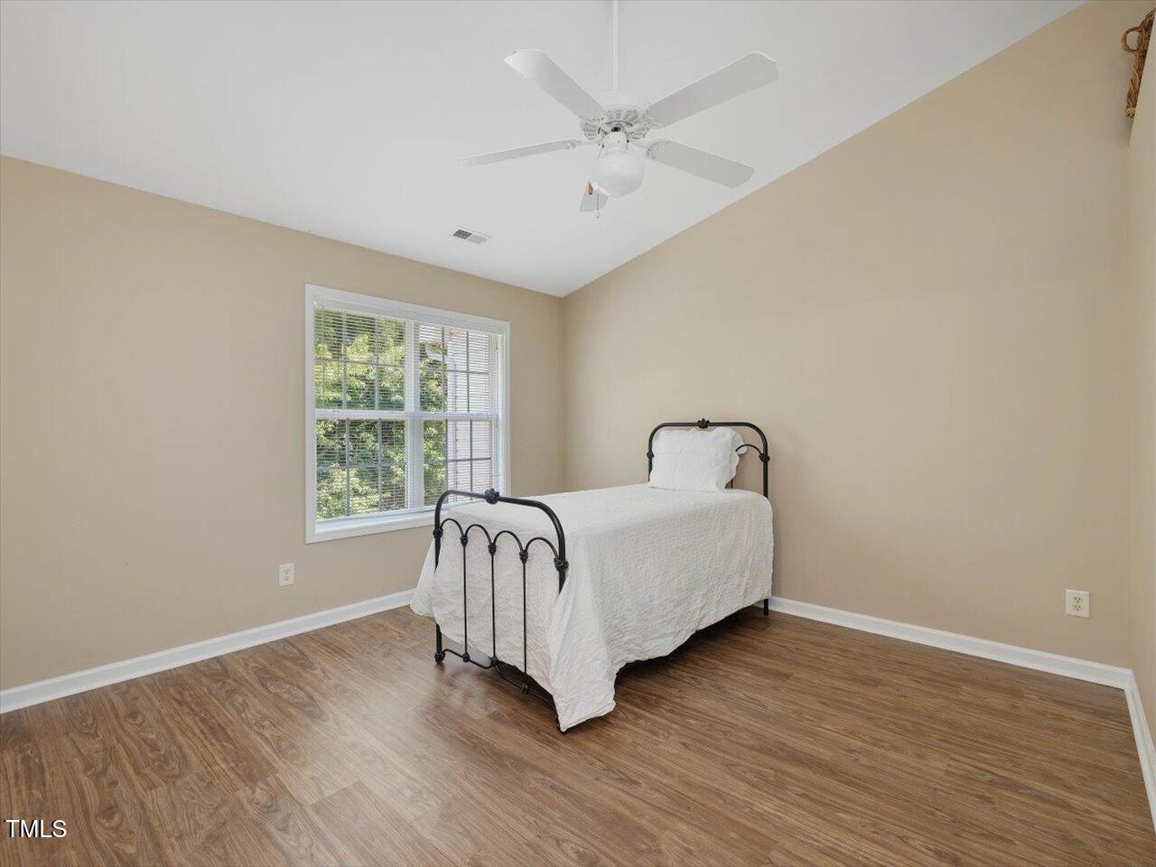 2021 Rivergate Road, Unit 102 Raleigh, NC 27614 - Photo 29 of 42 a bed sitting in a spacious bedroom next to a window