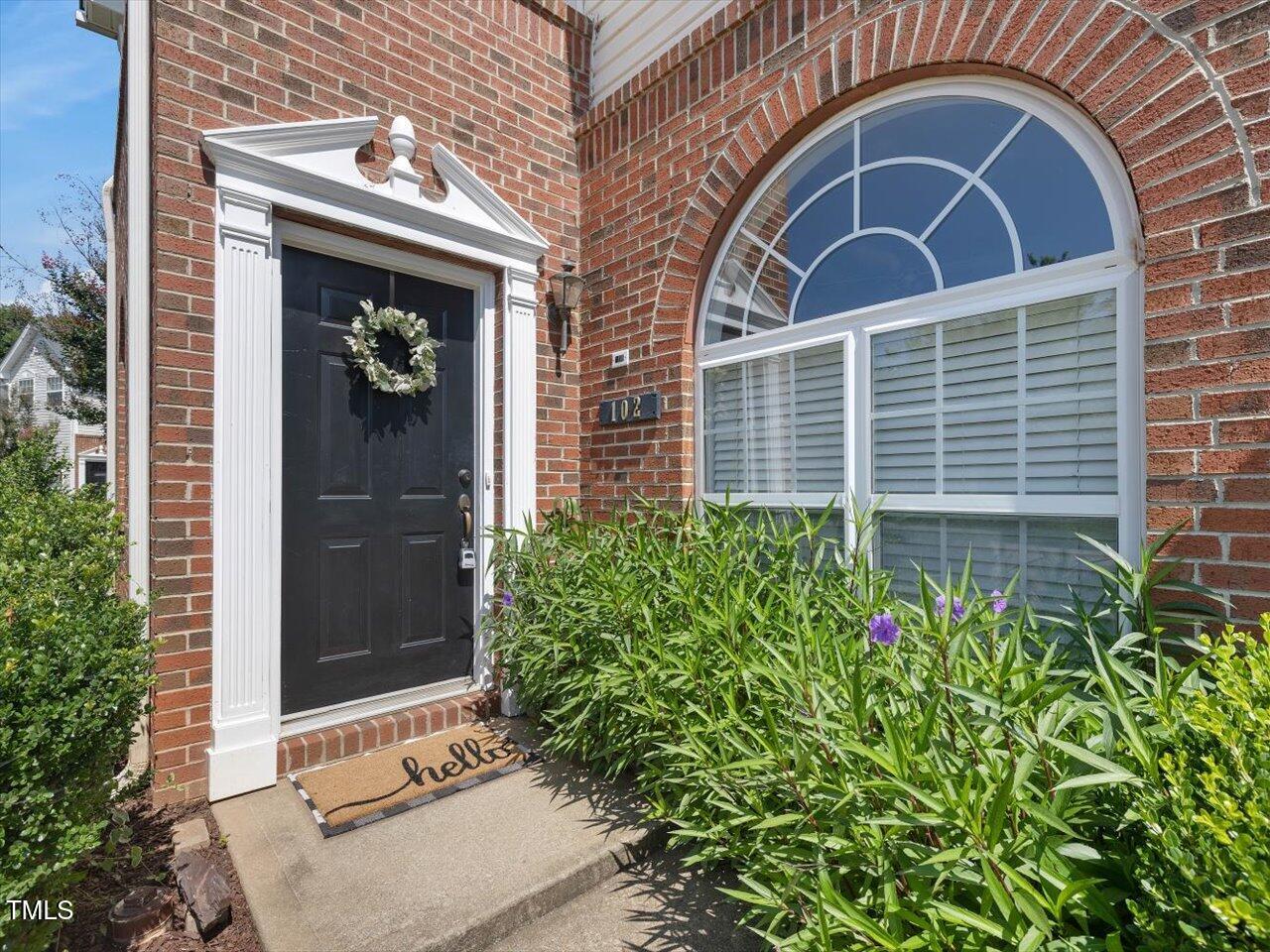 2021 Rivergate Road, Unit 102 Raleigh, NC 27614 - Photo 3 of 42 a front view of a house with plants