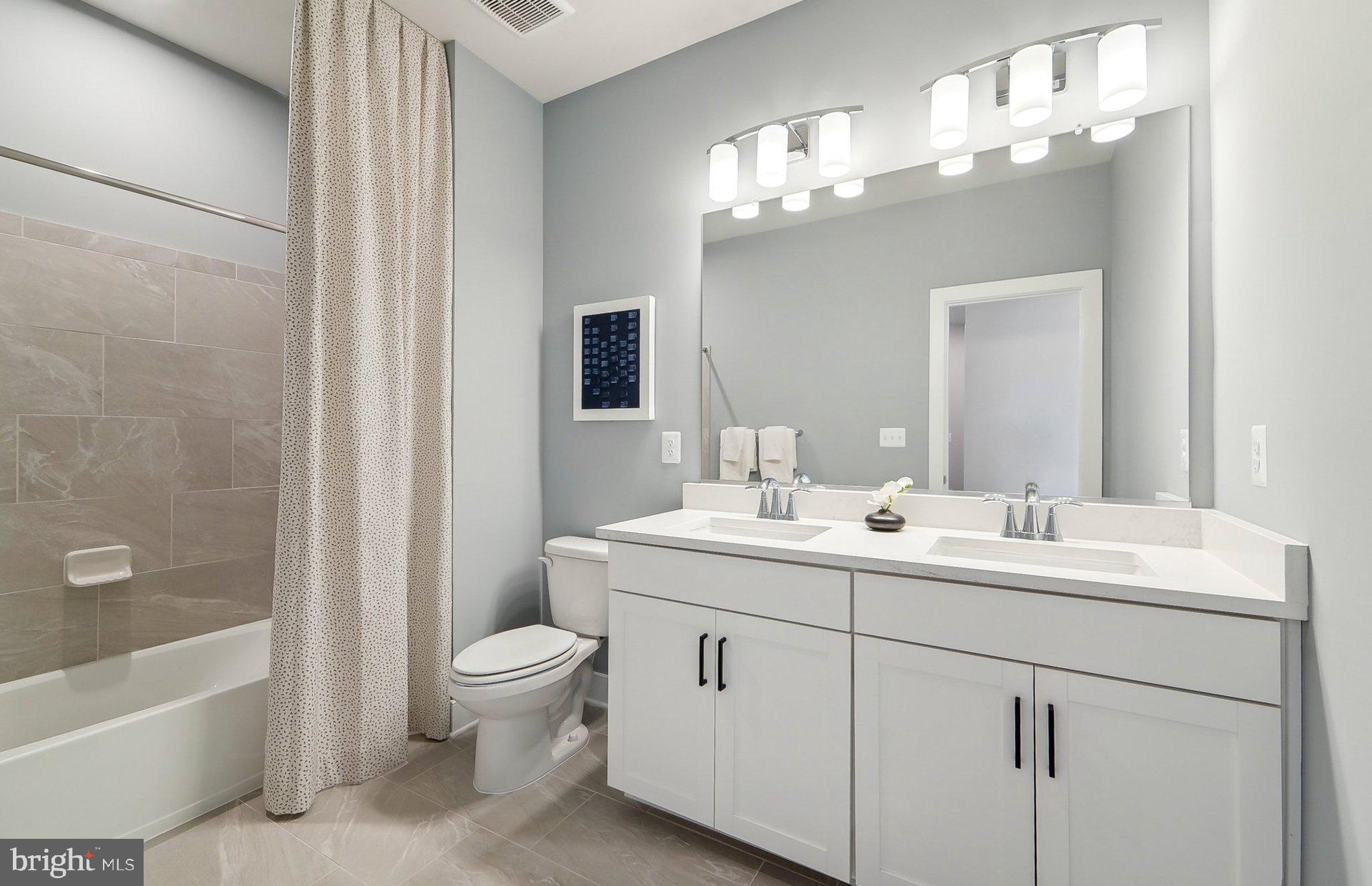 14623 Sourgum Road Boyds, MD 20841 - Photo 28 of 52 a bathroom with a toilet a sink a tub and mirror
