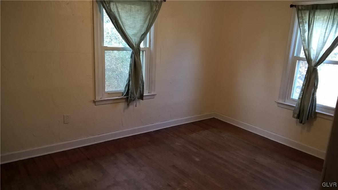 831 Leiszs Bridge Road Reading, PA 19605 - Photo 6 of 13 an empty room with wooden floor and windows