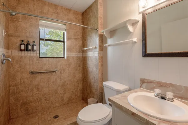 a bathroom with a sink toilet and shower