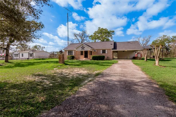 a view of a big yard with a house in the background