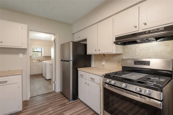 a kitchen with a stove and a refrigerator