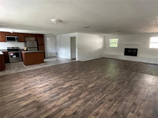a view of kitchen with furniture and flat screen tv