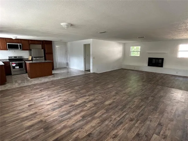 a view of kitchen with furniture and flat screen tv