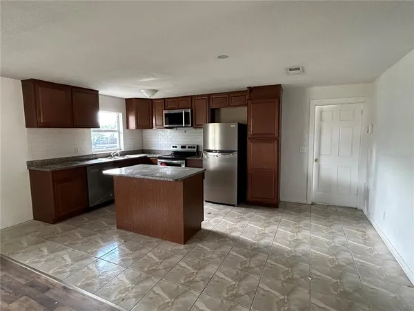 a kitchen with a refrigerator and a sink