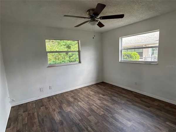 a view of room with window and ceiling fan