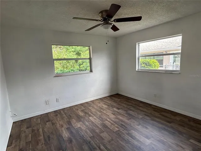 a view of room with window and ceiling fan