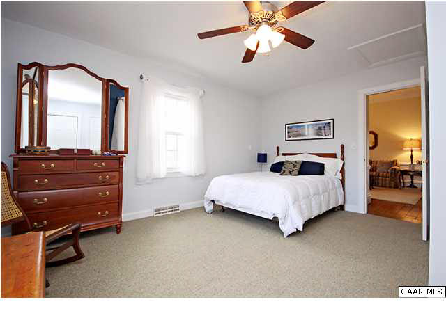 254 Dry Bridge Road Charlottesville, VA 22903 - Photo 14 of 26 a bedroom with a bed and wooden floor