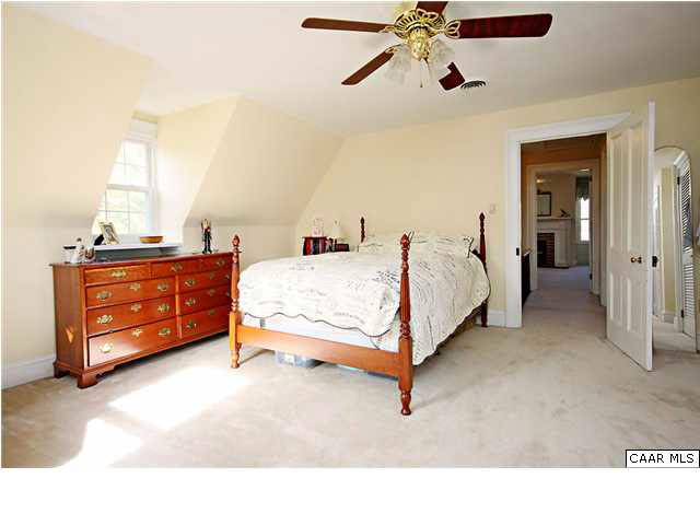 254 Dry Bridge Road Charlottesville, VA 22903 - Photo 17 of 26 a bed room with a bed and a chandelier