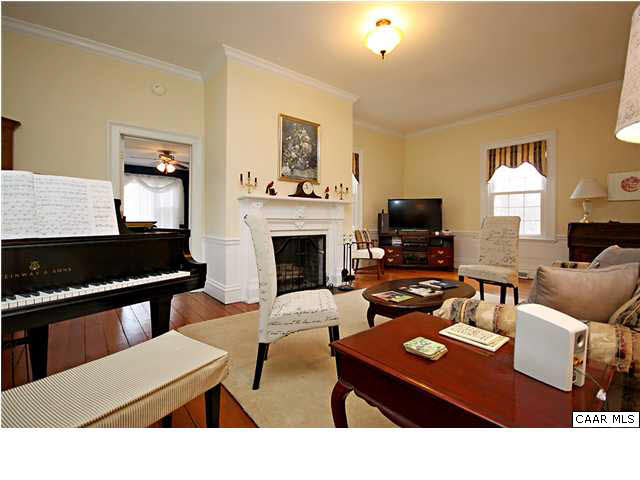 254 Dry Bridge Road Charlottesville, VA 22903 - Photo 8 of 26 a living room with furniture a fireplace and a flat screen tv