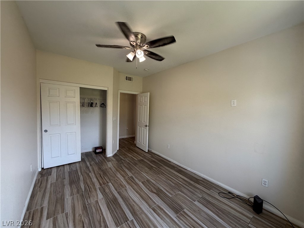 7701 West Robindale Road, Unit 236 Las Vegas, NV 89113 - Photo 15 of 15 Functional bedroom featuring rich wood-look tile flooring and ample closet space.