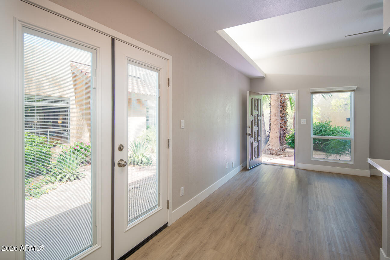 4540 North 44th Street, Unit 50 Phoenix, AZ 85018 - Photo 7 of 31 a view of an empty room with wooden floor and a window