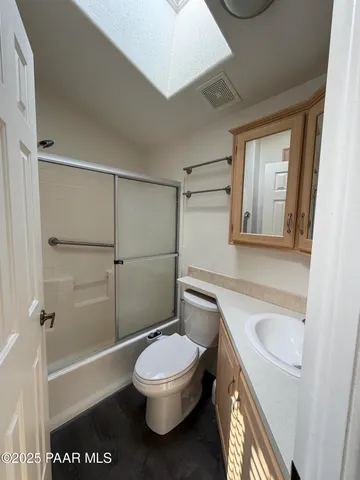 a bathroom with a toilet a sink and shower