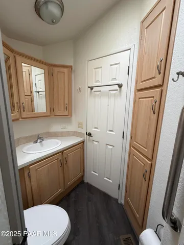 a bathroom with a sink a toilet a tub and shower