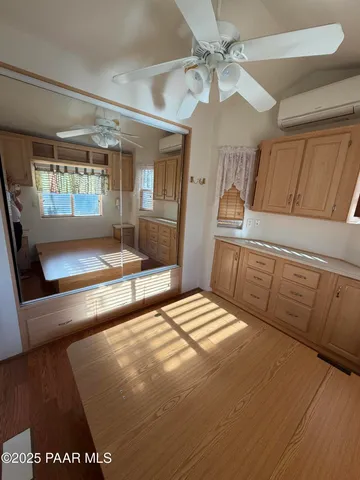 a bedroom with a bed and large window with the outer view