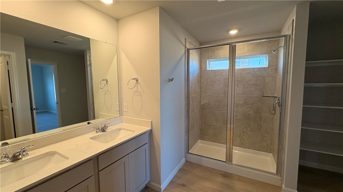 5403 Bear Run Bryan, TX 77807 - Photo 4 of 6 a bathroom with a shower sink and mirror