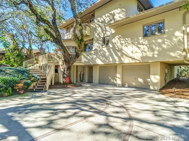 a view of a house with a yard and garage