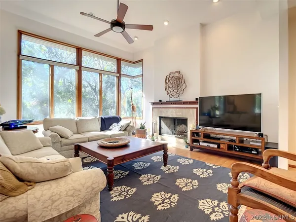 a living room with furniture a flat screen tv and a fireplace