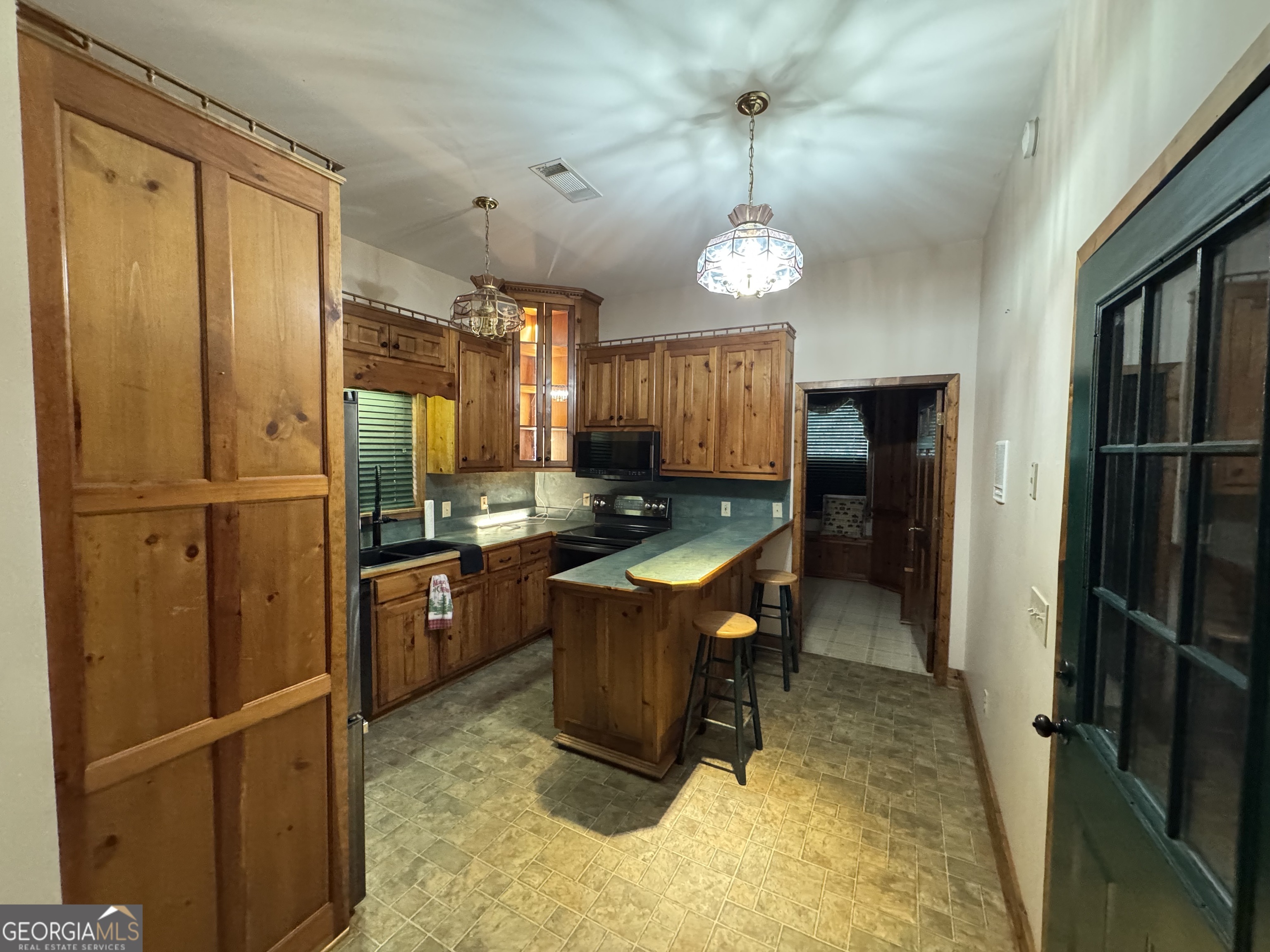 1045 Pleasant Hill Road Jasper, GA 30143 - Photo 13 of 20 a room with stainless steel appliances kitchen island granite countertop furniture a refrigerator and a stove top oven