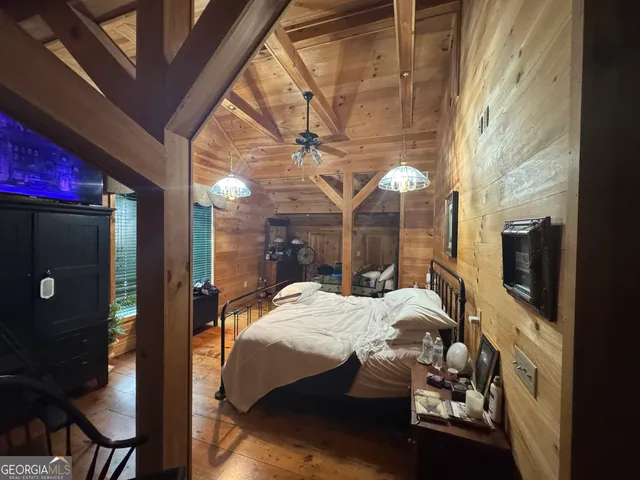 a room with furniture a flat screen tv and a bed