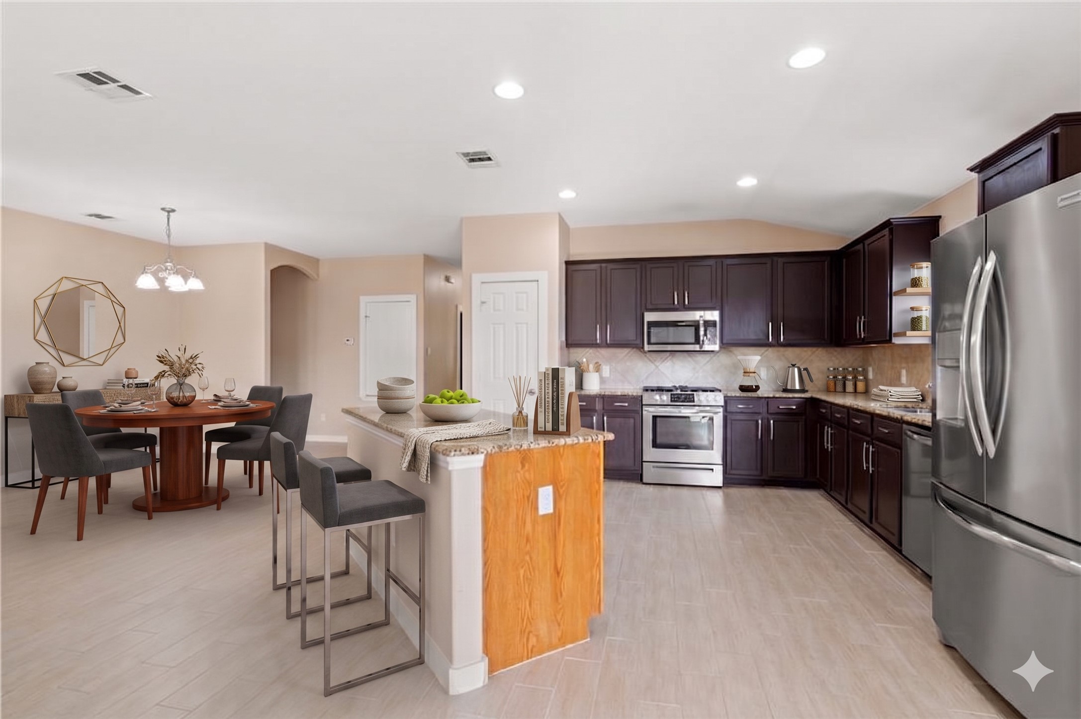 20224 Merlin Falcon Trail Pflugerville, TX 78660 - Photo 2 of 40 An open concept kitchen features warm cabinetry, granite countertops, and an inviting dining area.