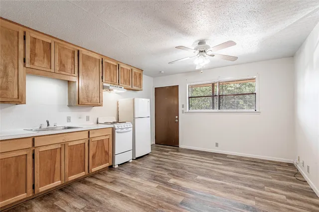 a kitchen with stainless steel appliances granite countertop a refrigerator sink and cabinets