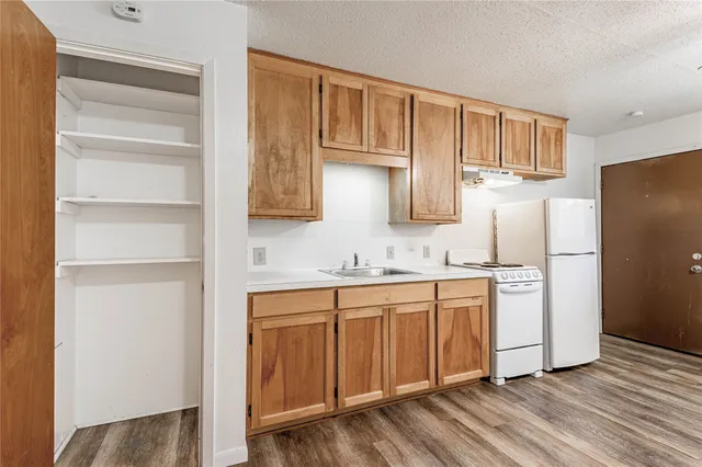 a kitchen with stainless steel appliances granite countertop a refrigerator sink and cabinets