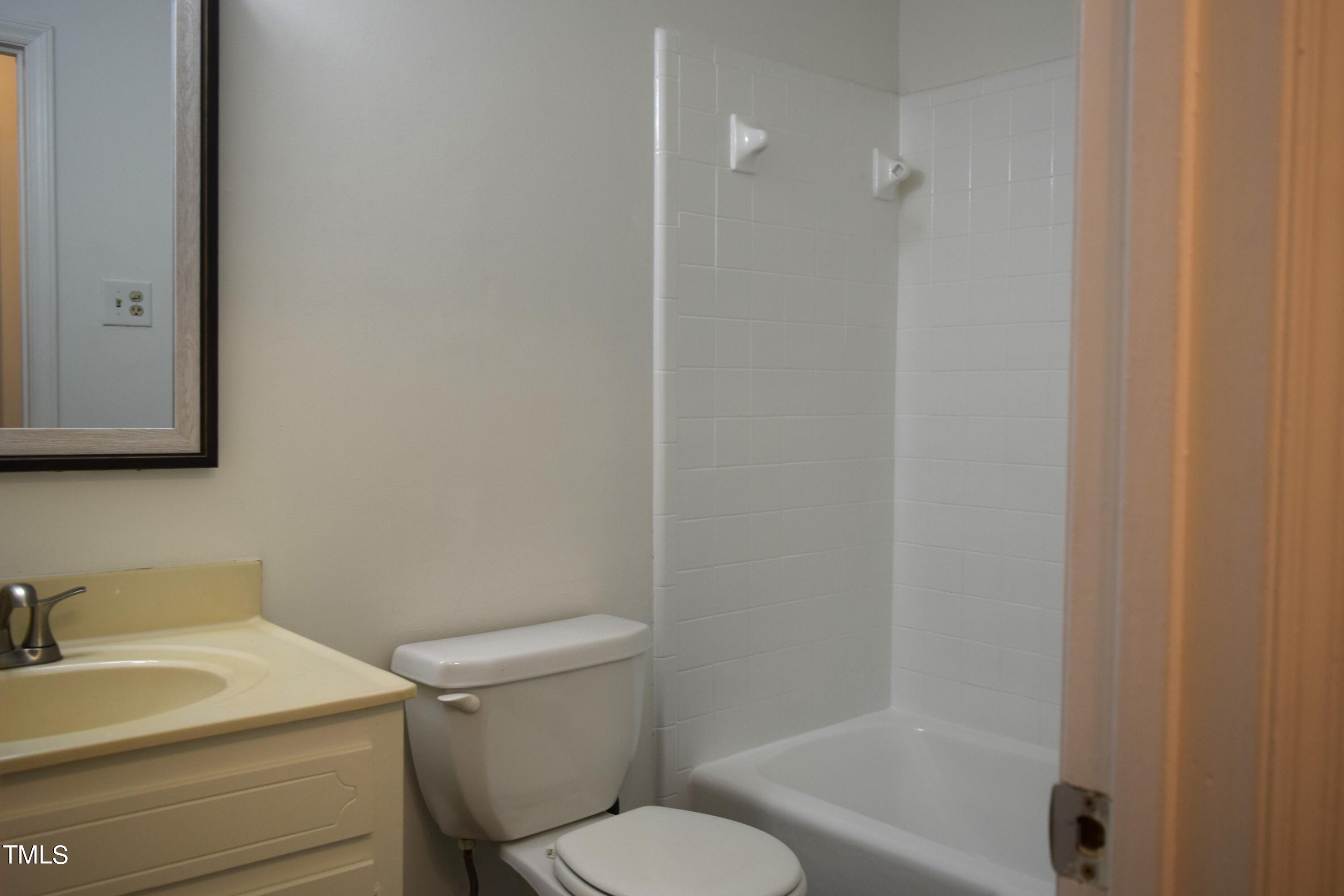 2731 Umstead Road Durham, NC 27712 - Photo 16 of 22 a white toilet sitting next to a bathroom sink