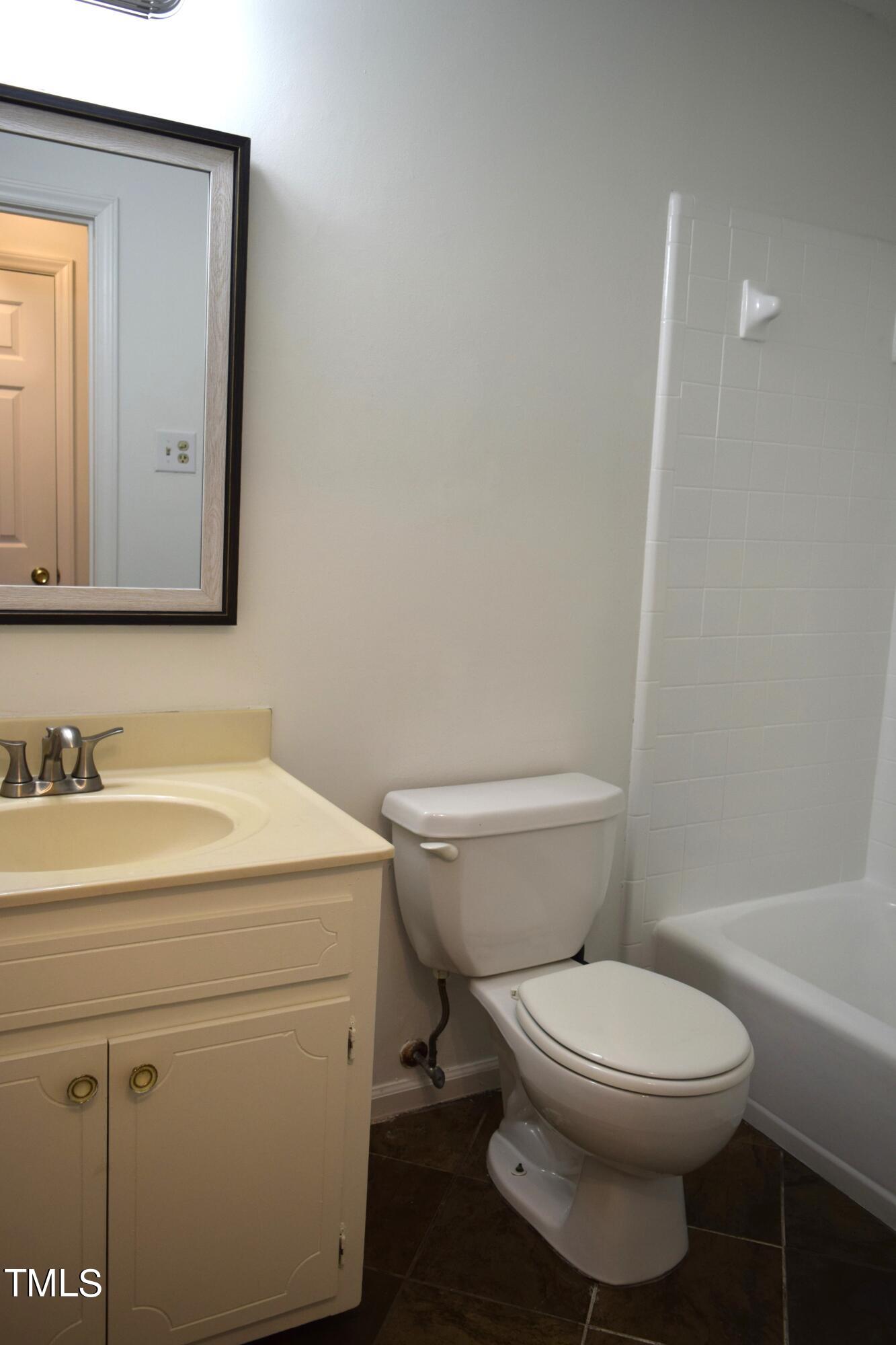 2731 Umstead Road Durham, NC 27712 - Photo 17 of 22 a bathroom with a toilet a sink and mirror