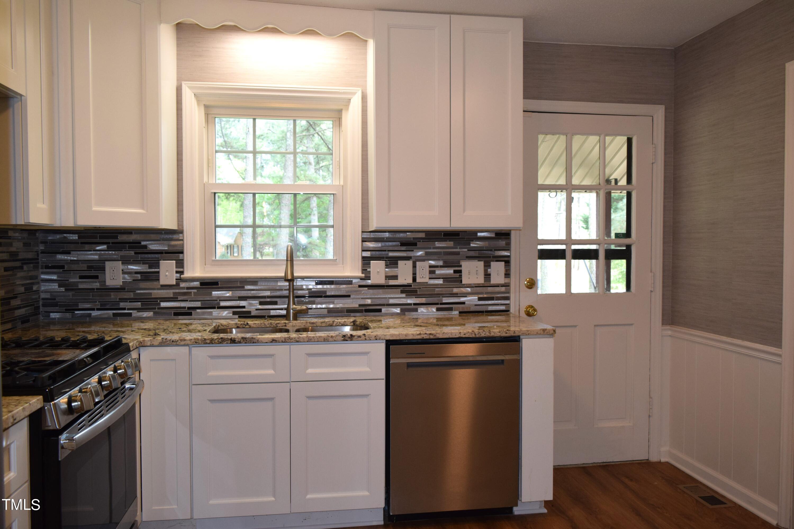 2731 Umstead Road Durham, NC 27712 - Photo 5 of 22 a kitchen with stainless steel appliances granite countertop a stove a sink and a microwave