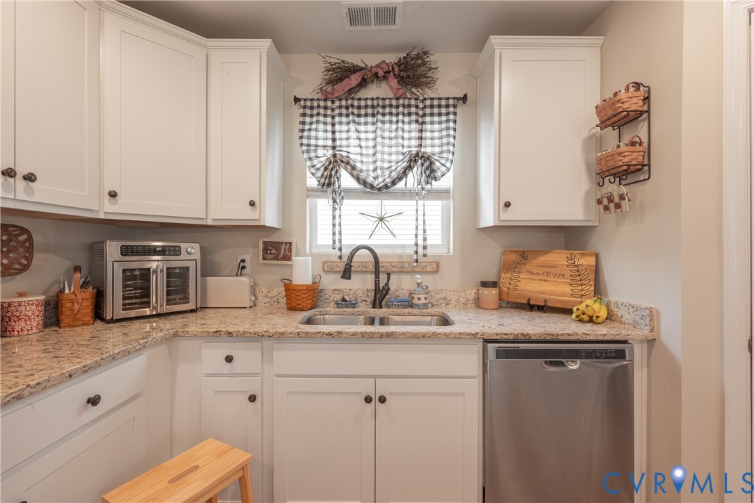 17854 Meriwether Lewis Street Ruther Glen, VA 22546 - Photo 17 of 39 Kitchen featuring white cabinetry with dark hardwa