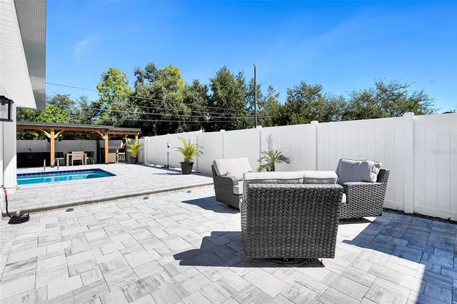a kitchen with stainless steel appliances kitchen island a refrigerator and a stove top oven