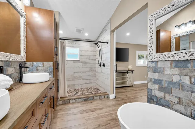a bathroom with a double vanity sink mirror and shower