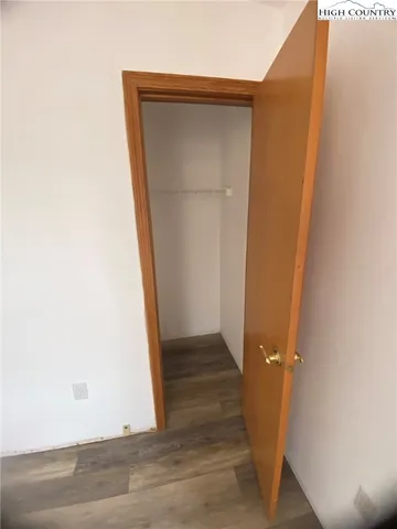 an empty room with wooden floor