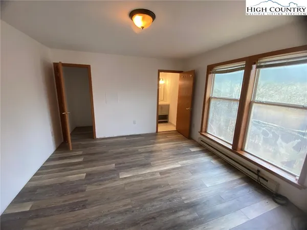a white toilet sitting next to a shower