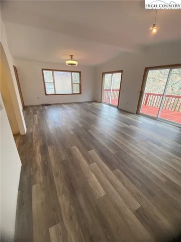 a view of wooden floor and windows in a room