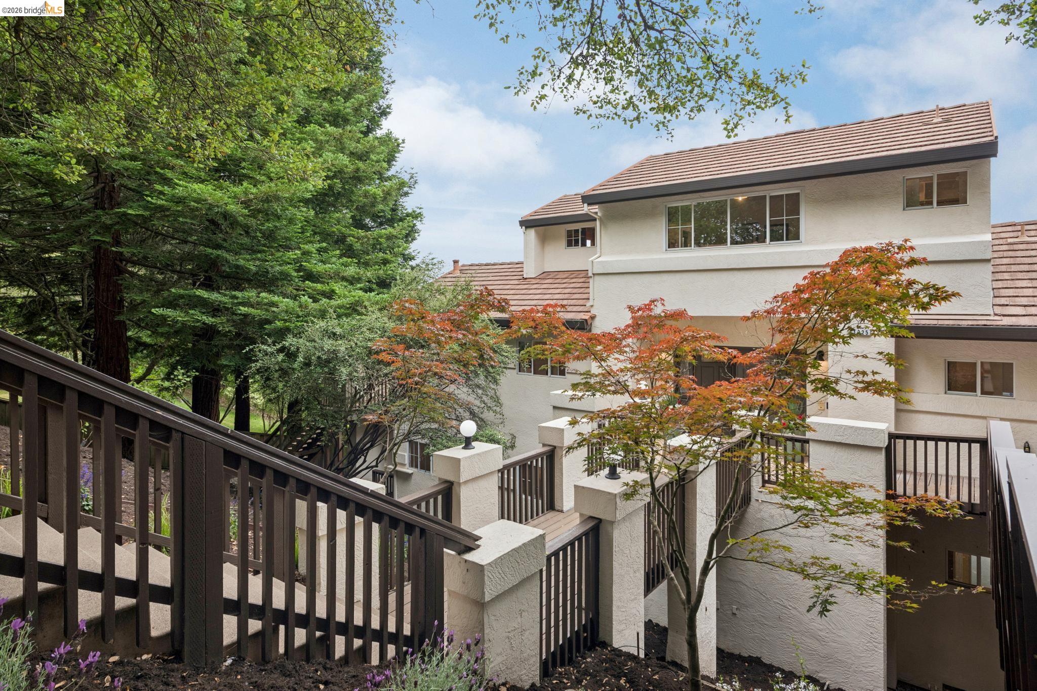 1325 Drury Road Berkeley, CA 94705 - Photo 2 of 71 Multi-level stucco exterior featuring a terra cotta tile roof and expansive windows